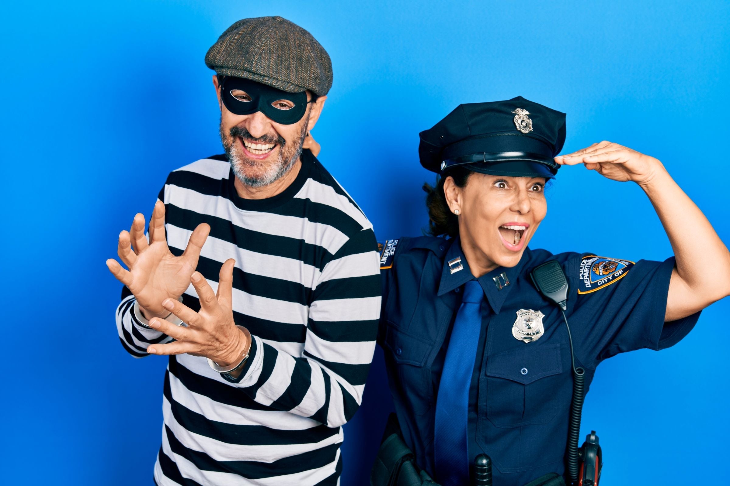 people wearing cops & robbers fancy dress costumes