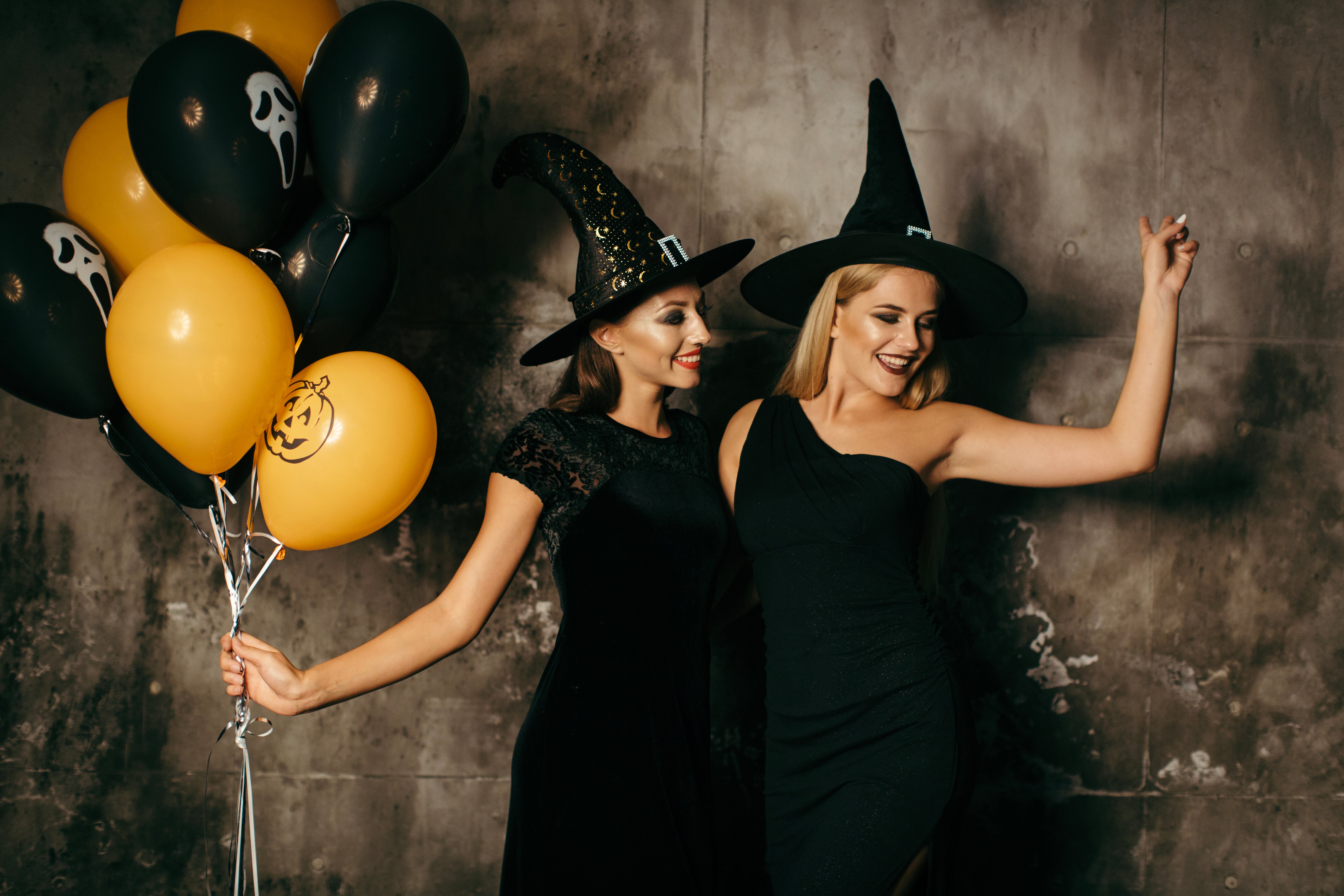 2 women dressed as witches at a Halloween party