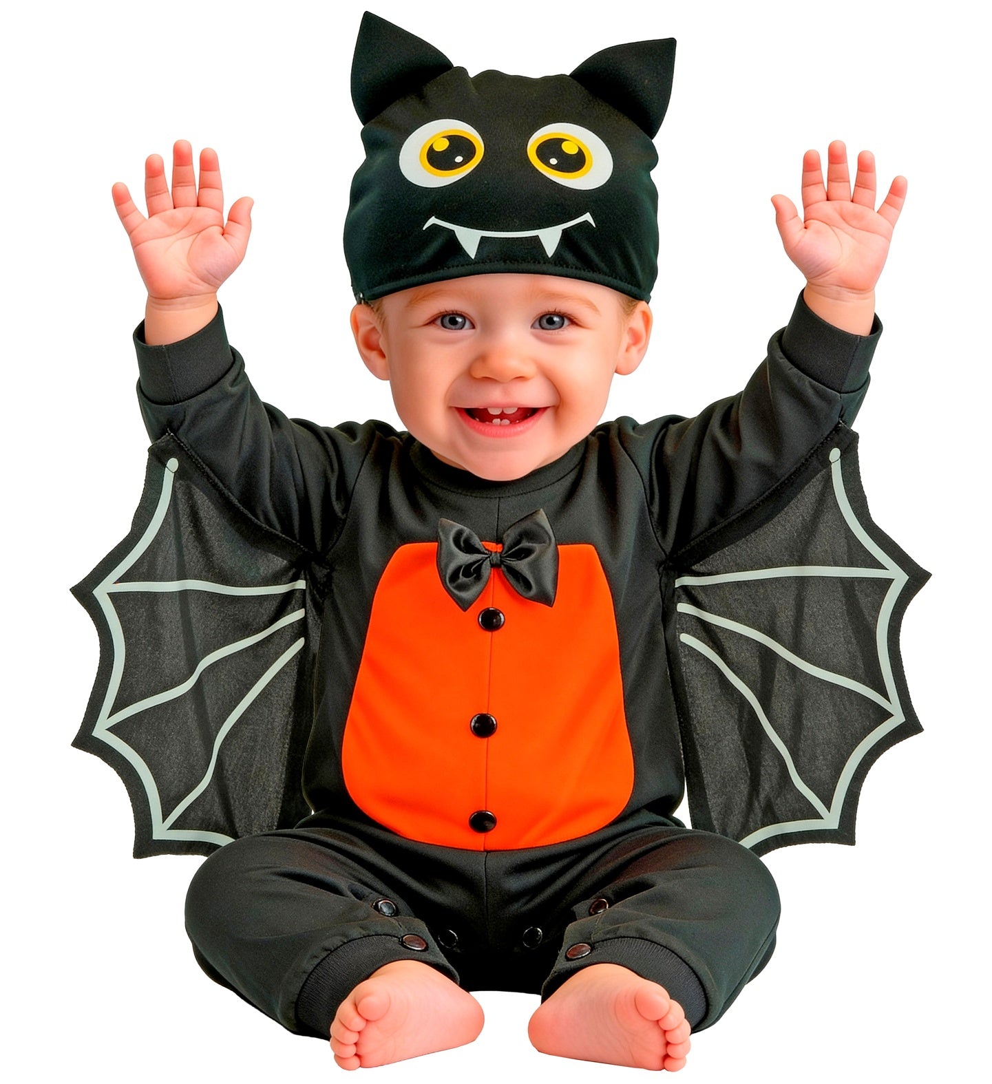 An adorable young child sitting comfortably on the floor wearing a plush black bat costume jumpsuit with a purple tummy patch, spread-out wings, and a matching hood with pointy bat ears.