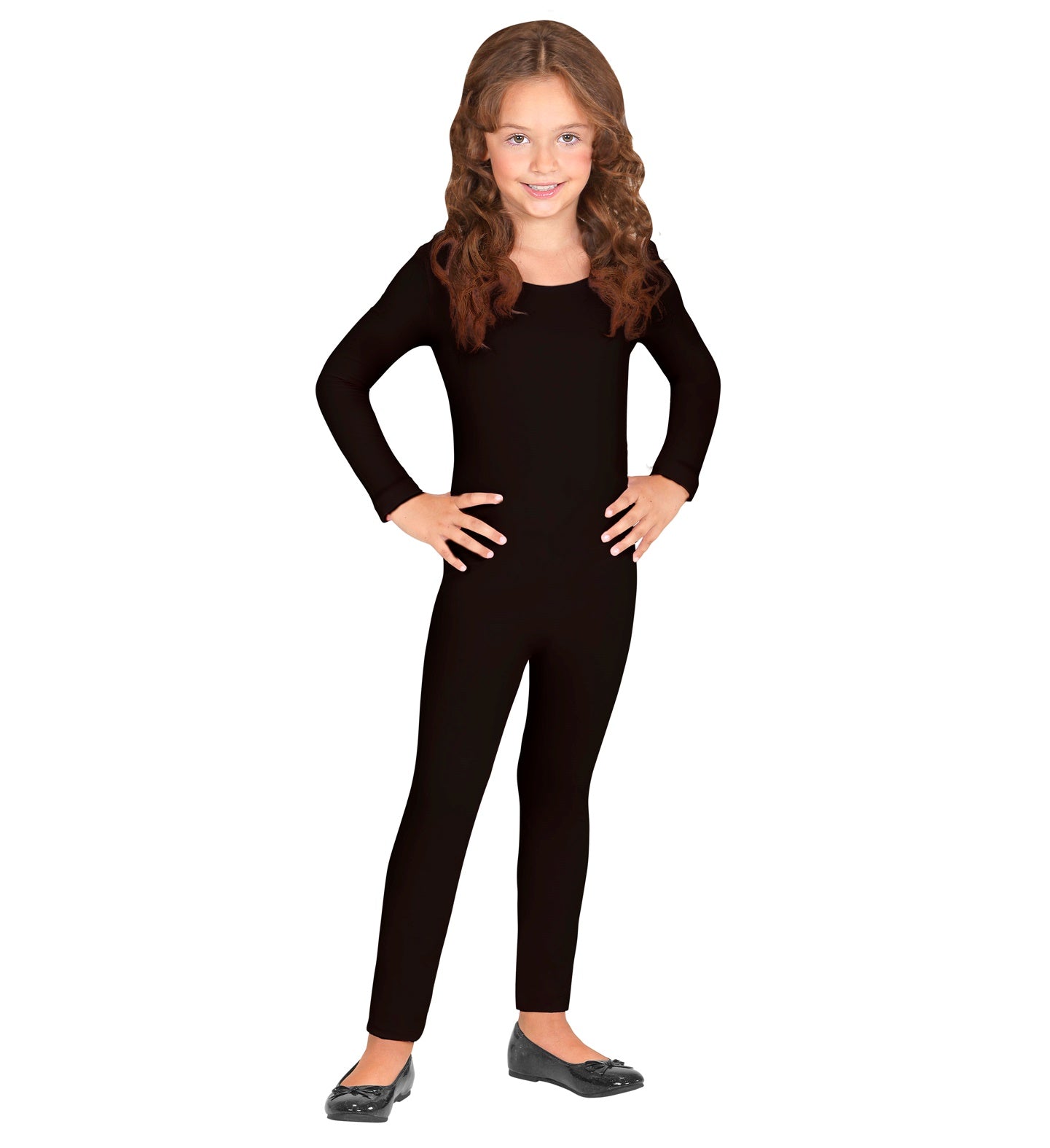 A young girl with long wavy hair smiling while posing with hands on hips, wearing a sleek, long-sleeved children's black bodysuit base layer with black flat shoes.