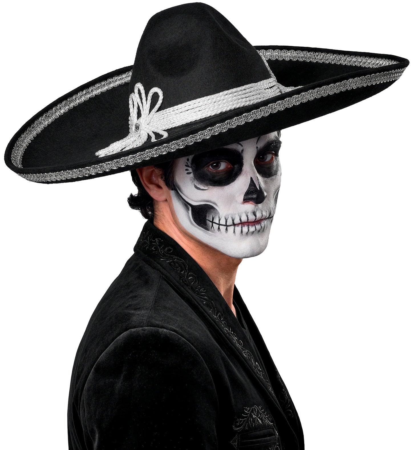 A man wearing a black sombrero with silver trim and a white decorative bow, along with Day of the Dead style skull face paint and a black embroidered jacket, shown against a plain white background.