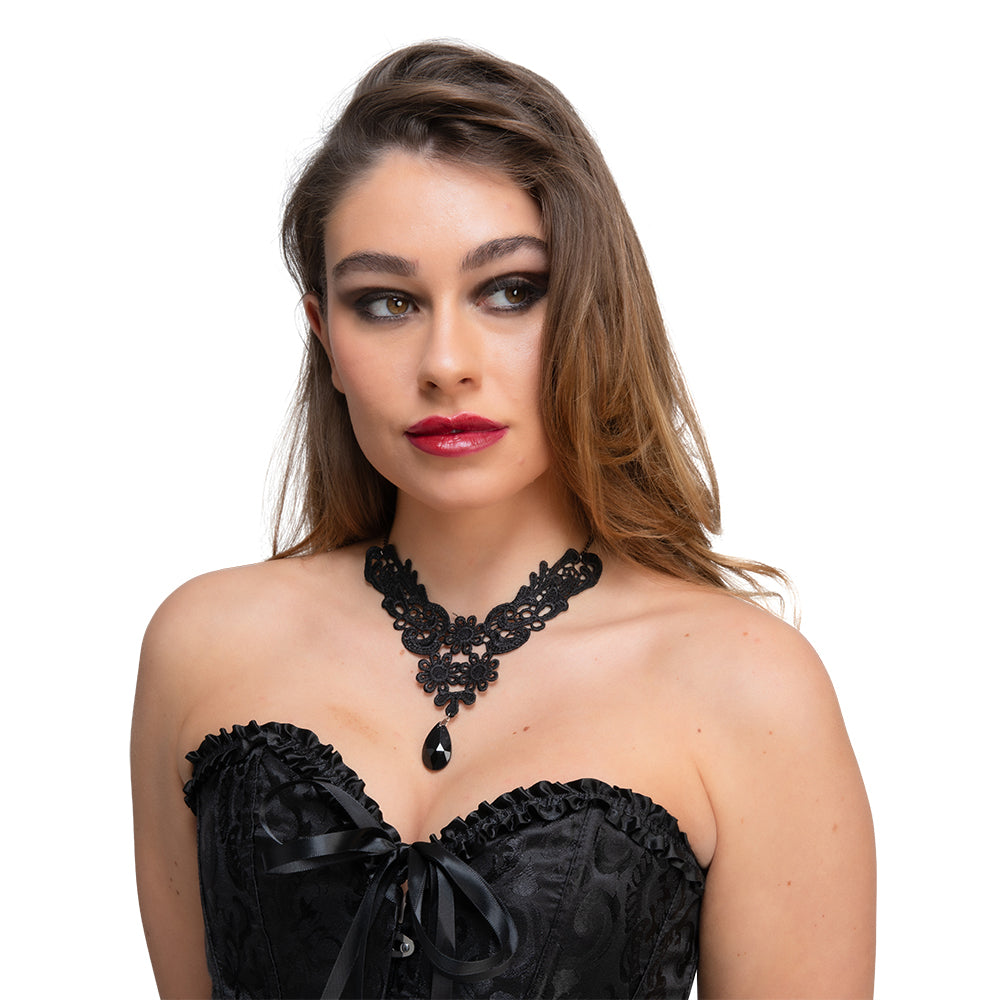 A woman with dramatic eye makeup and red lipstick models a black lace gothic choker with a large black teardrop gem.