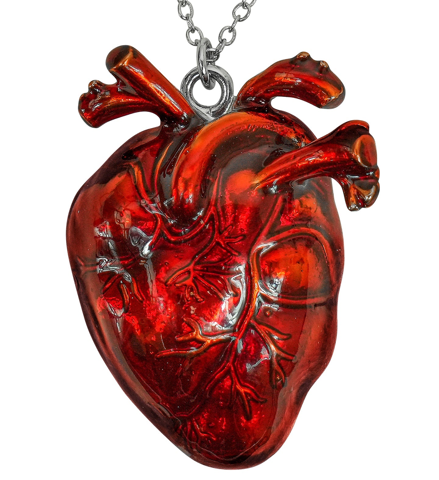 A close-up of a gory pendant shaped like a realistic, anatomical human heart with a glossy, bloody red finish.