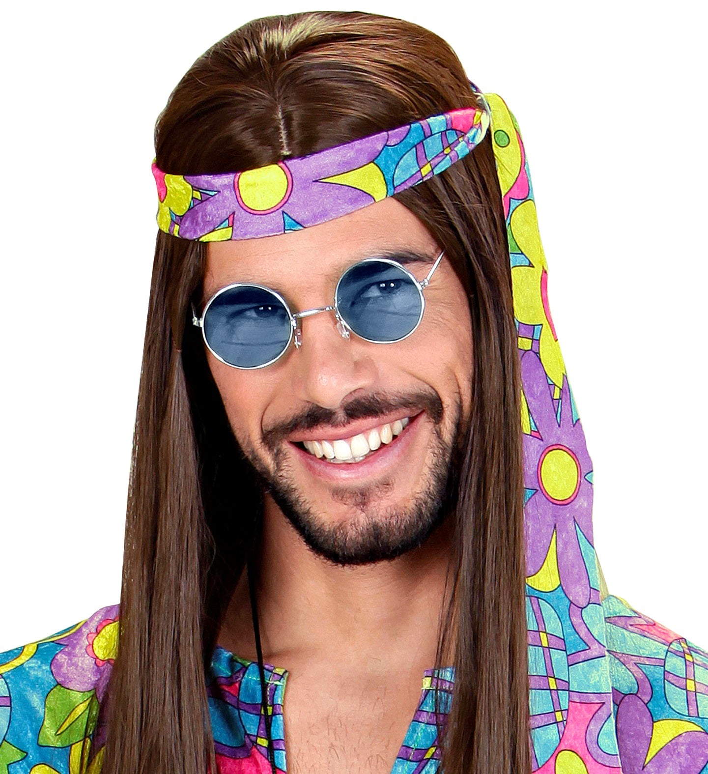 A man with a beard and long brown hair, wearing a colorful patterned top, a floral headband, and round, blue-tinted glasses with gold-colored frames, smiling against a white background.