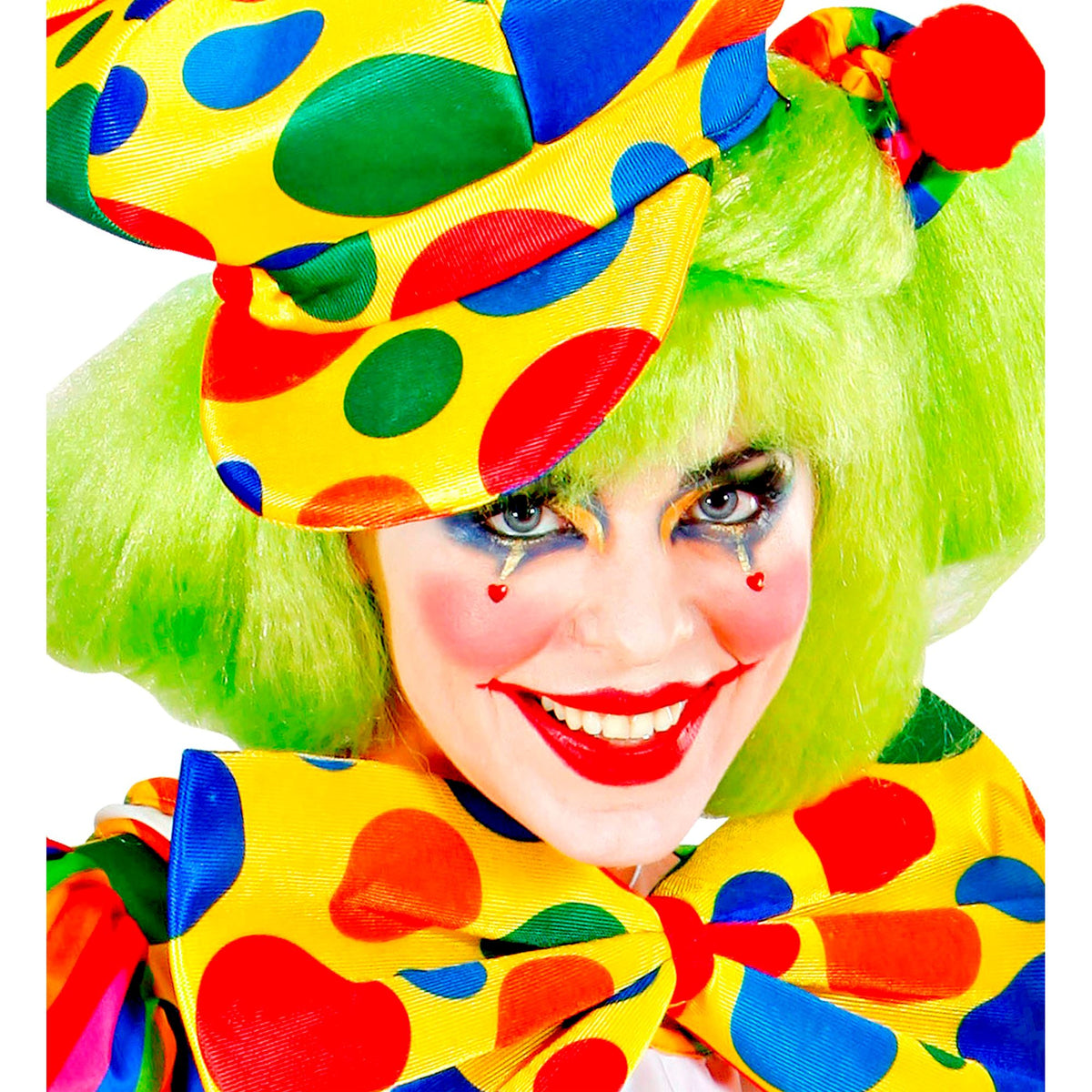 A close-up of a person wearing a bright clown costume with a yellow hat and matching bow tie covered in large red, blue, green, and orange polka dots, paired with a neon green wig and theatrical makeup.
