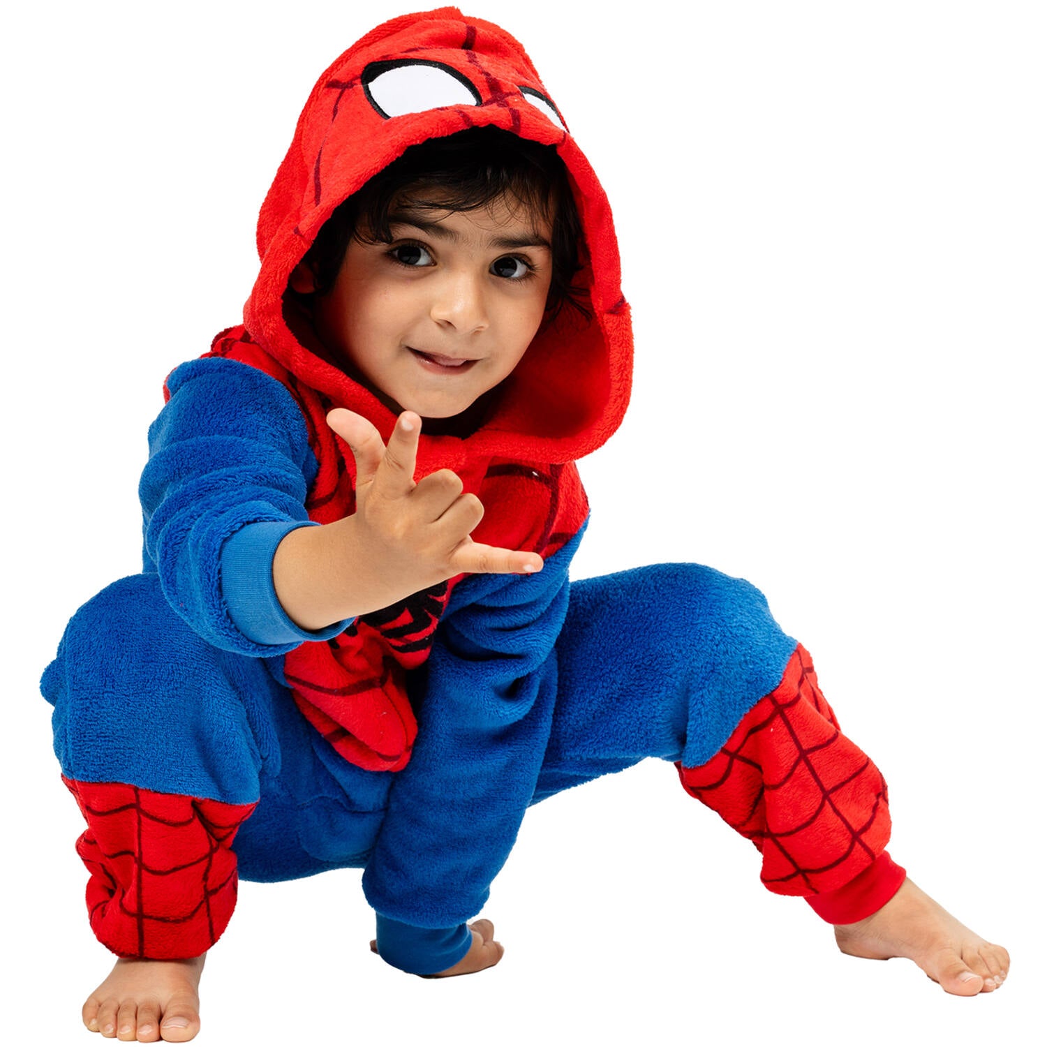 A young child crouched in a classic superhero landing pose wearing a plush, officially licensed Spider-Man onesie with the character hood up.