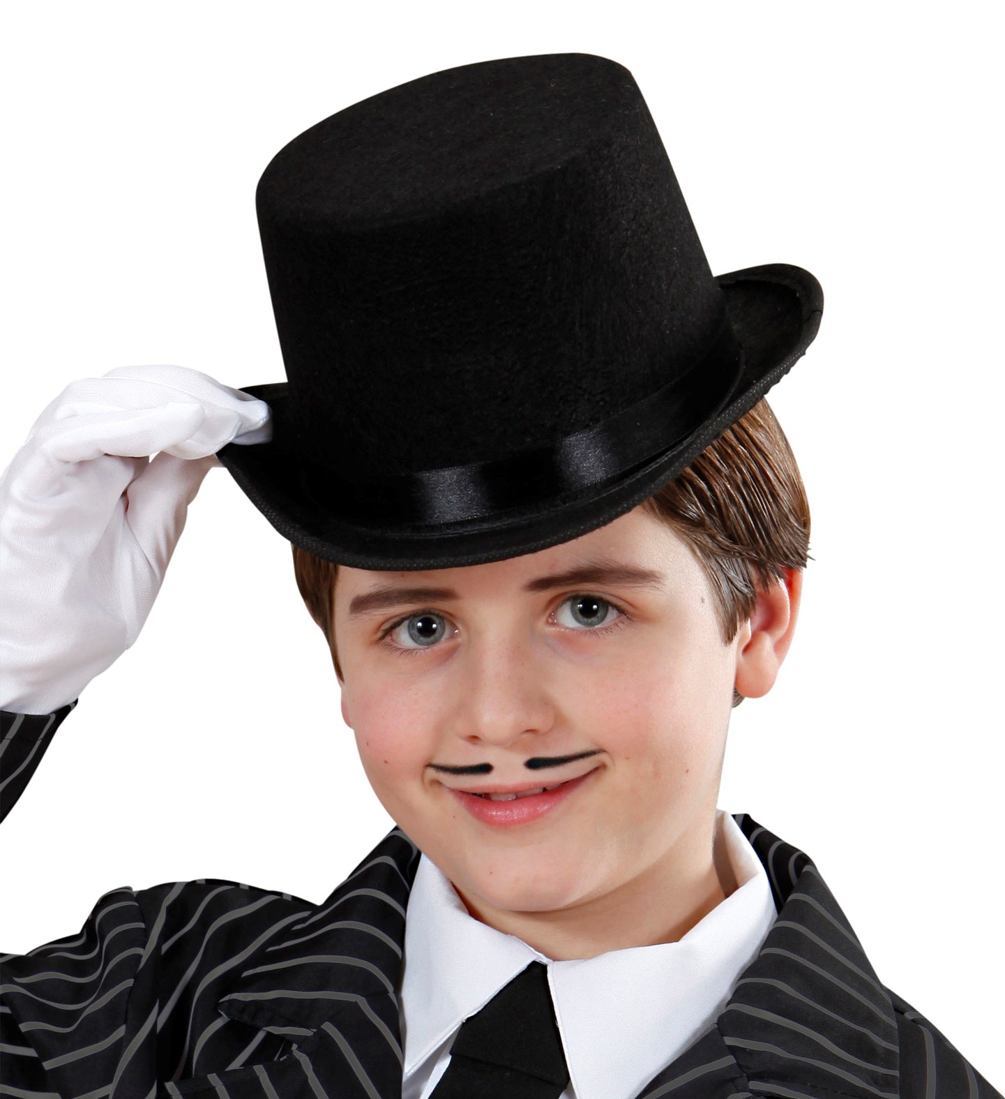 A boy smiling and tipping a black felt top hat, dressed in a striped suit and white shirt.