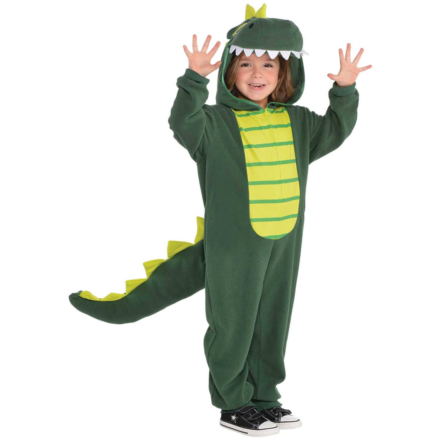 A smiling child with arms playfully raised, wearing a cozy green zip-up dinosaur onesie costume featuring a light green striped belly, a hood shaped like a dinosaur head with soft white teeth, and an attached spiked tail.