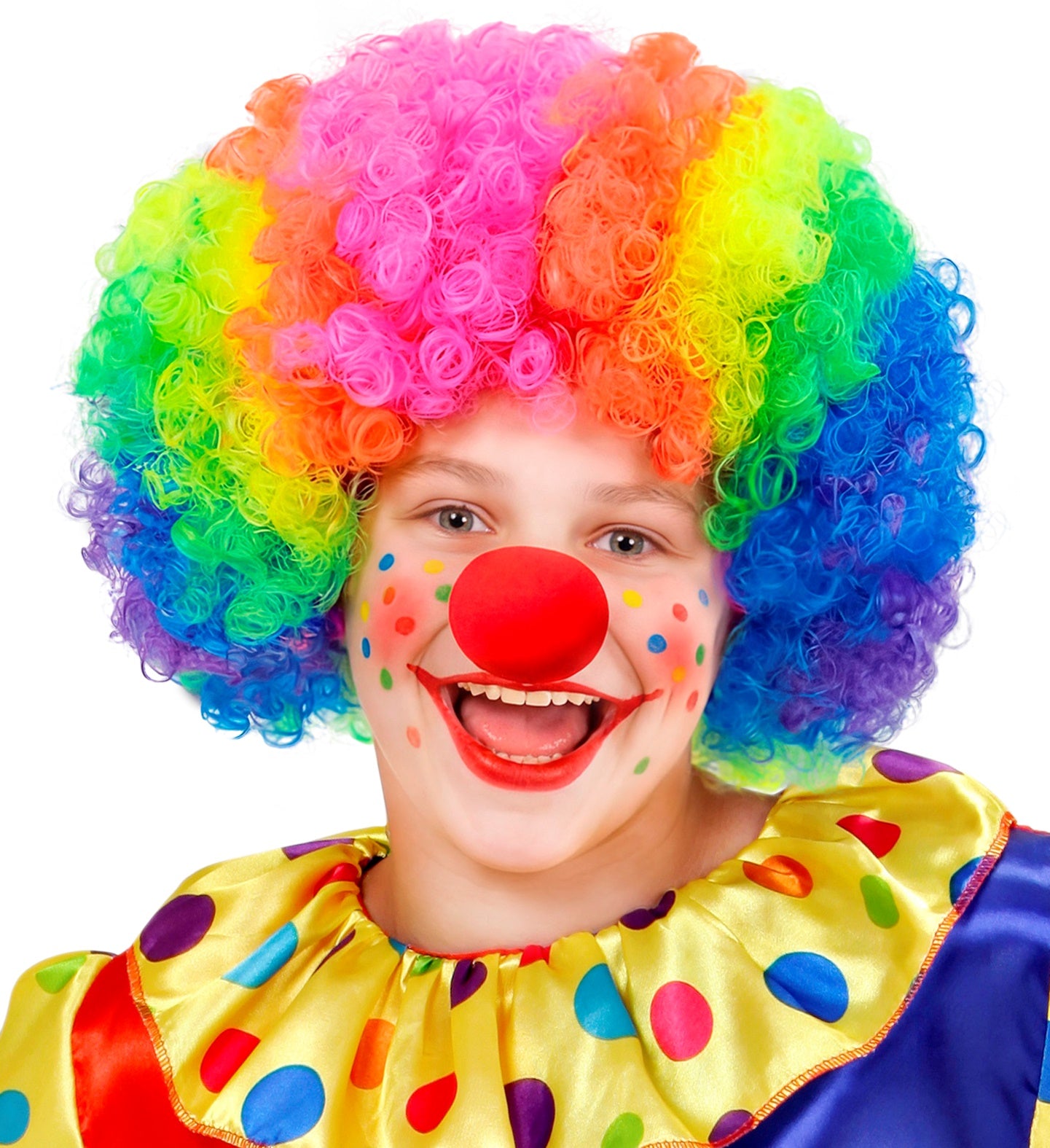 A cheerful young clown wearing a bright rainbow curly wig, colorful polka dot face paint, a yellow polka dot collar, and a classic red sponge clown nose.