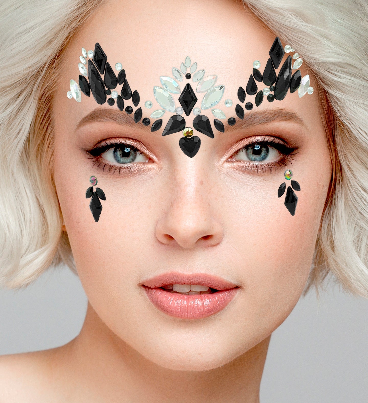 Close-up of a symmetrical black gem arrangement across the forehead and matching teardrop gems on the cheeks.