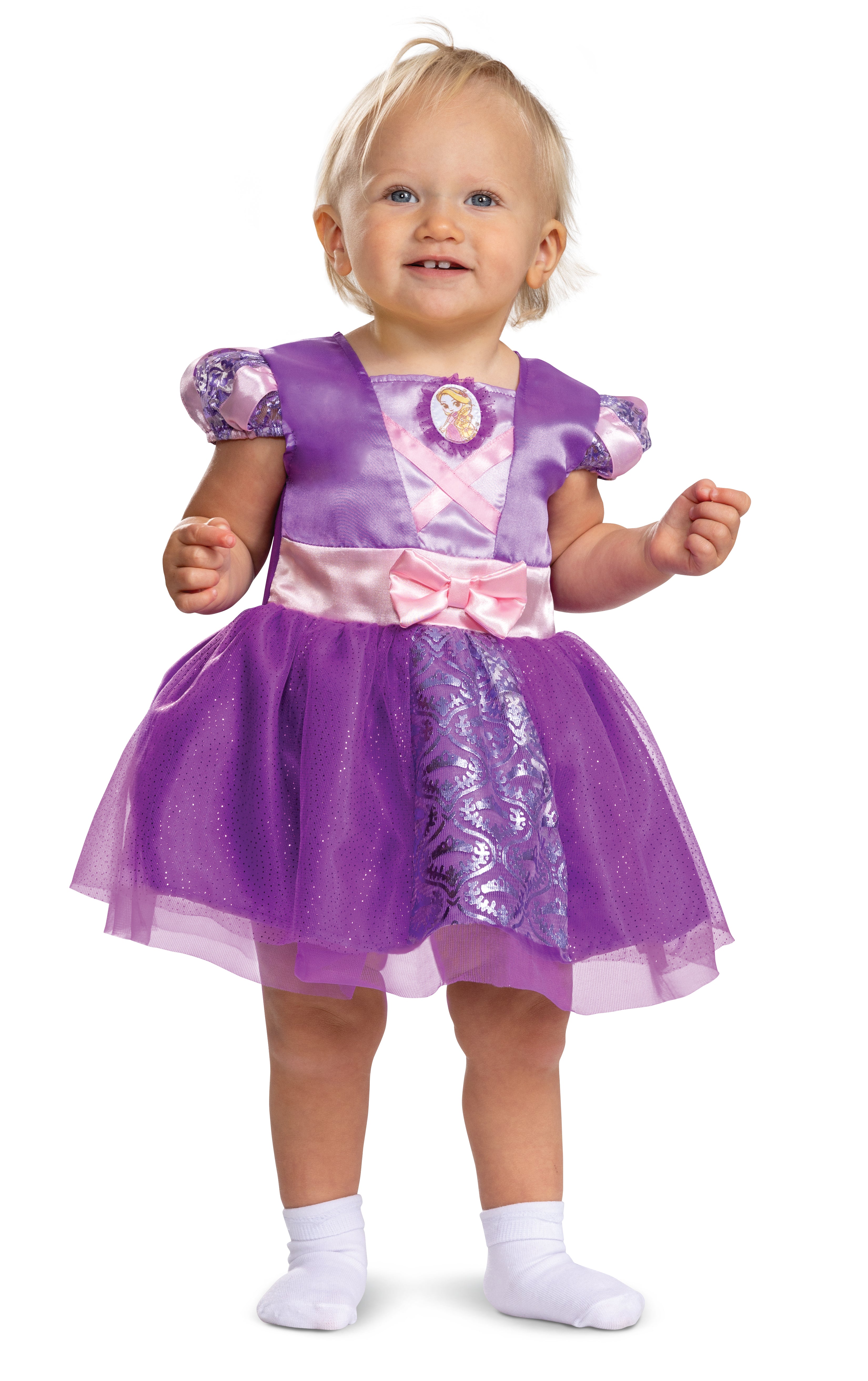 Toddler standing in the Rapunzel purple dress, showing the glittery tulle tutu skirt and silver foil floral print panel.
