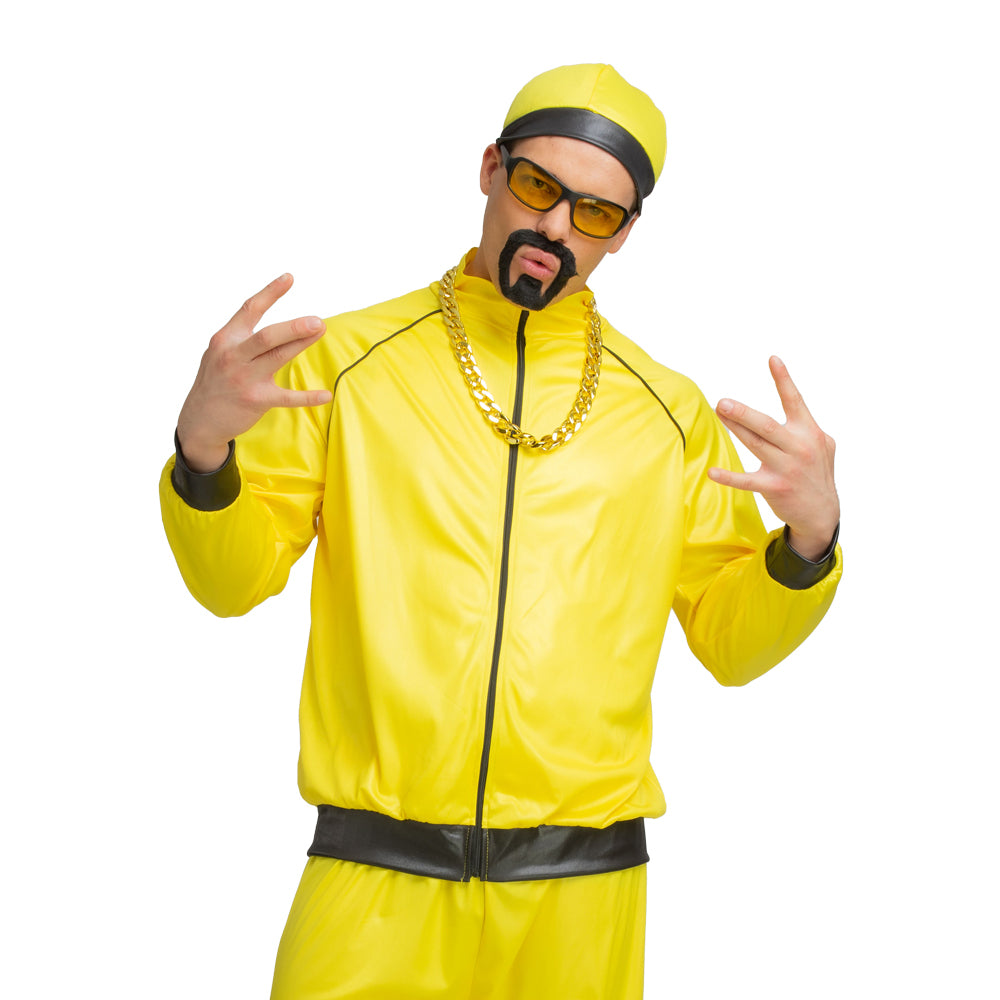Close-up front view of Ali G rapper costume showing bright yellow shiny jacket with black piping trim, gold-finish plastic chain, yellow-tinted sunglasses, black cap and stick-on goatee beard