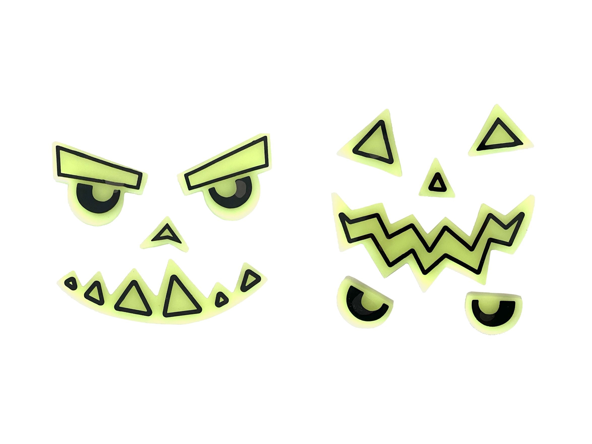 Two sets of glow-in-the-dark gel pumpkin face stickers, each featuring distinct black-outlined eyes, noses, and mouths in green-yellow translucent gel, isolated on a white background. One set has an angry, mischievous expression, and the other a more traditional jagged jack-o'-lantern look.