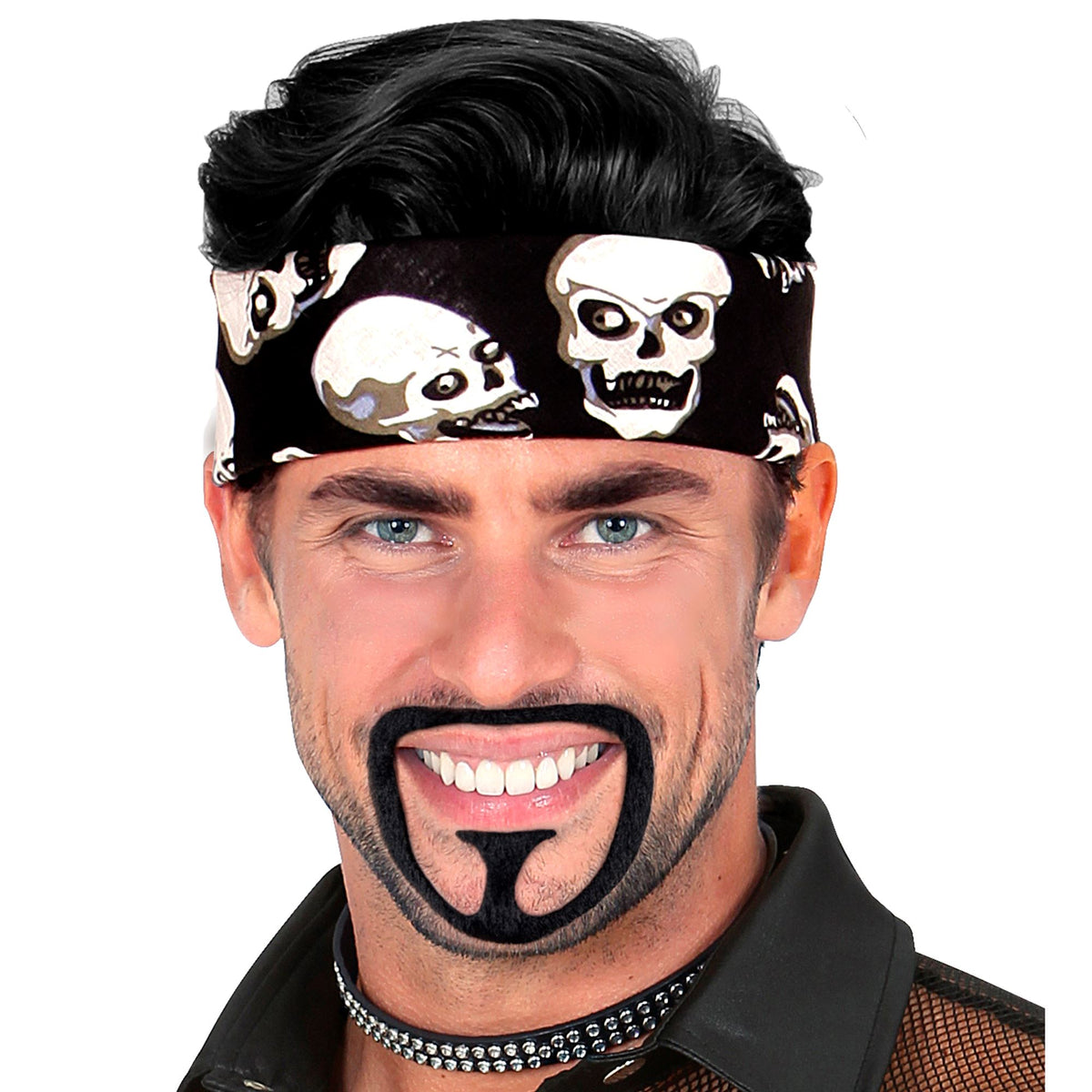 A smiling man wearing a skull-print bandana and a studded black collar, modeling a black stick-on goatee beard costume accessory.