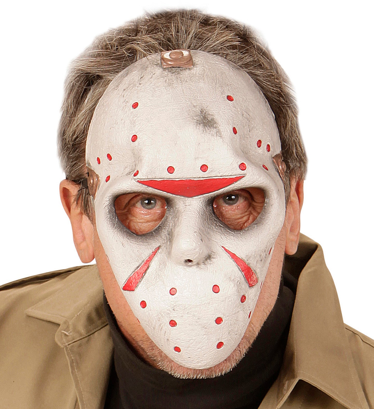 A man wearing a weathered white horror hockey mask with red markings, inspired by the Jason Voorhees character.