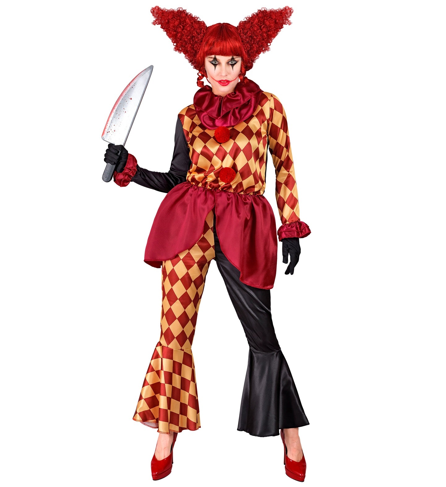 A woman in a colorful but creepy clown costume, holding a toy knife. The costume includes a ruffled neck collar, a coat with one black sleeve and one harlequin-patterned sleeve, and a pair of mismatched pants with one leg in a harlequin pattern and the other in black, flared at the bottom. The person is wearing a wild, curly red wig and has clown makeup on their face