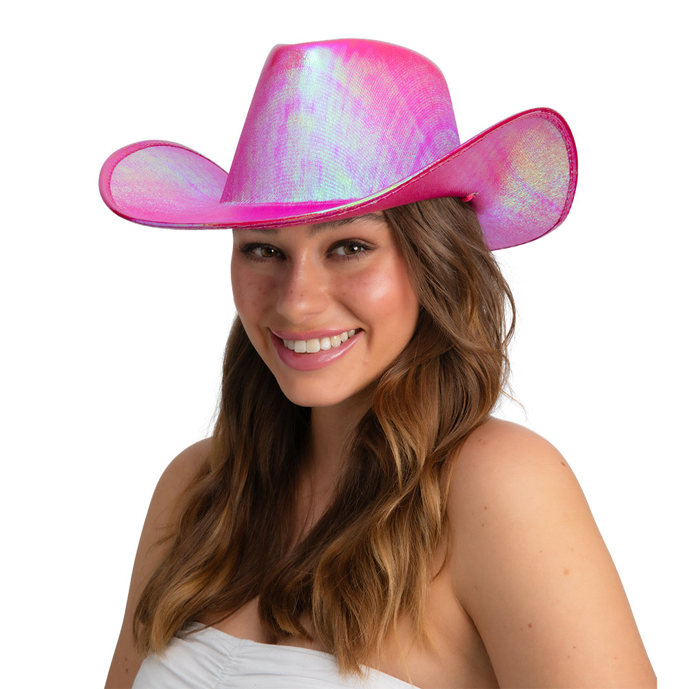 Woman smiling while wearing a sparkly hot pink iridescent ladies Texan cowboy hat, with long brown hair.
