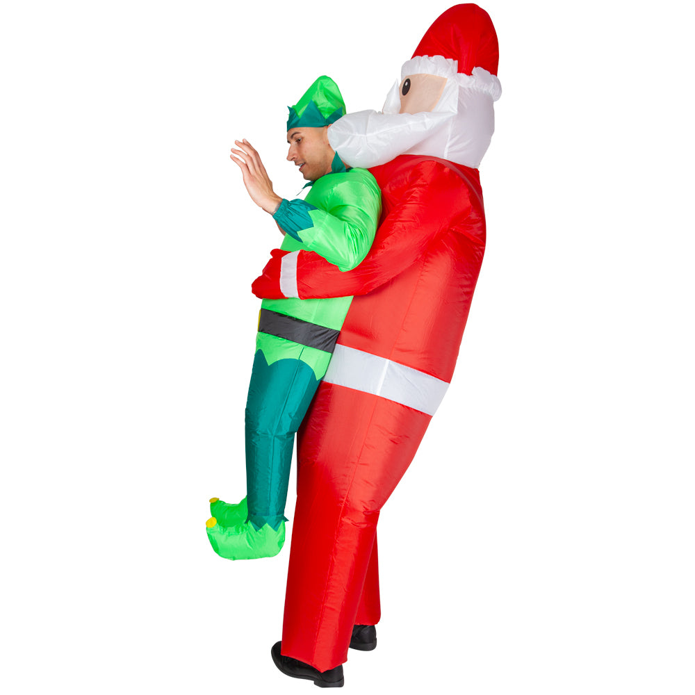 A person in the inflatable carry me elf costume, looking surprised while Santa appears to be holding them up.