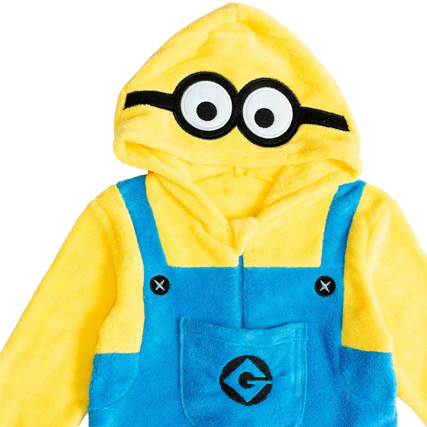 A close-up shot focusing on the hood of the kids' Minions onesie, showcasing the embroidered goggles and big round character eyes.