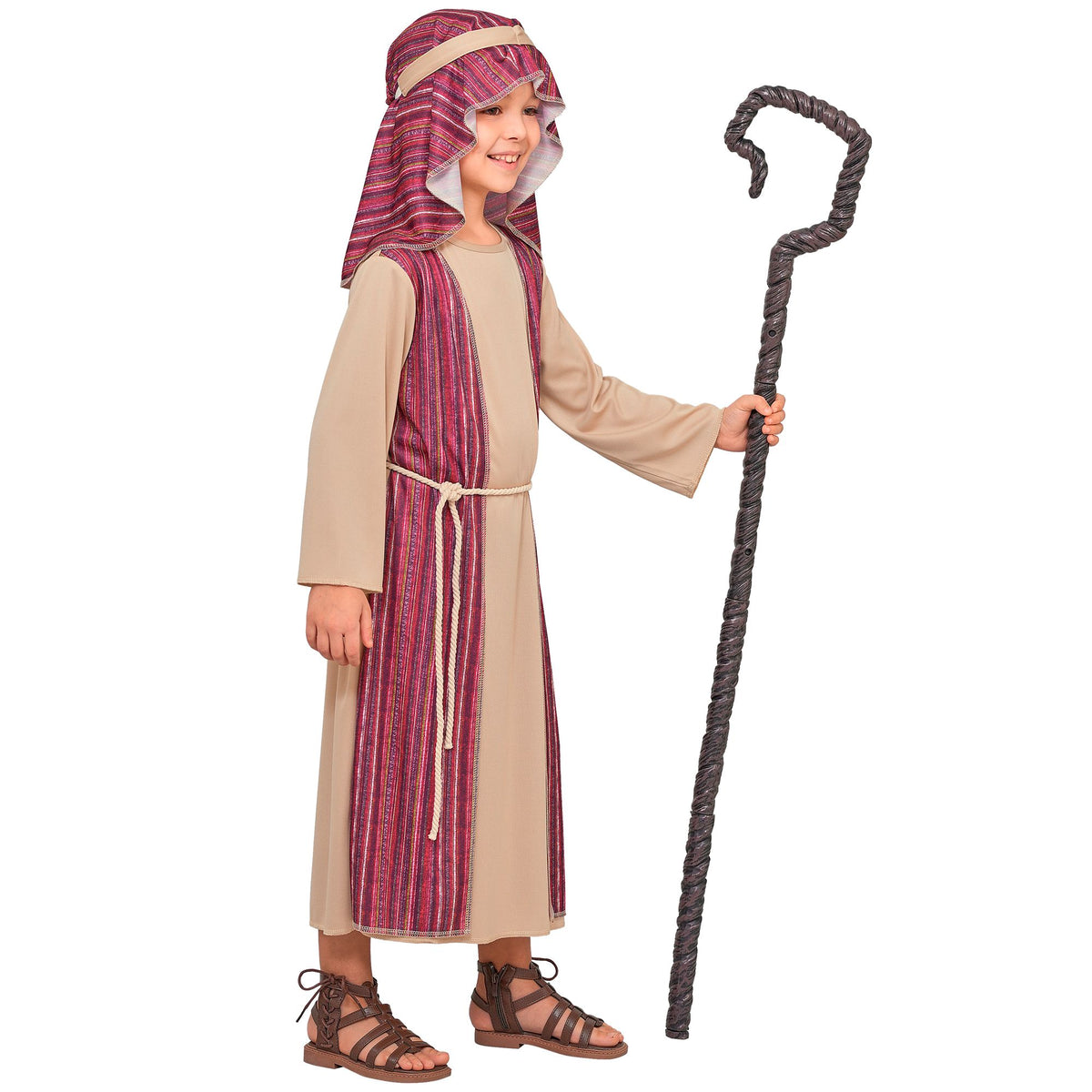 A child modeling a biblical or historical costume consisting of a beige robe with a purple and red striped front panel, a matching head covering, and brown sandals, while holding a dark twisted staff against a plain white background.