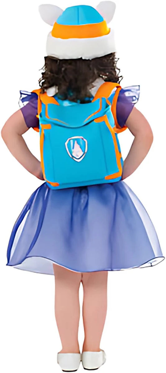 The back view of a child modeling a Paw Patrol Everest costume, showing the blue and orange wearable pup backpack with the Paw Patrol shield logo and the flared purple sparkling skirt.