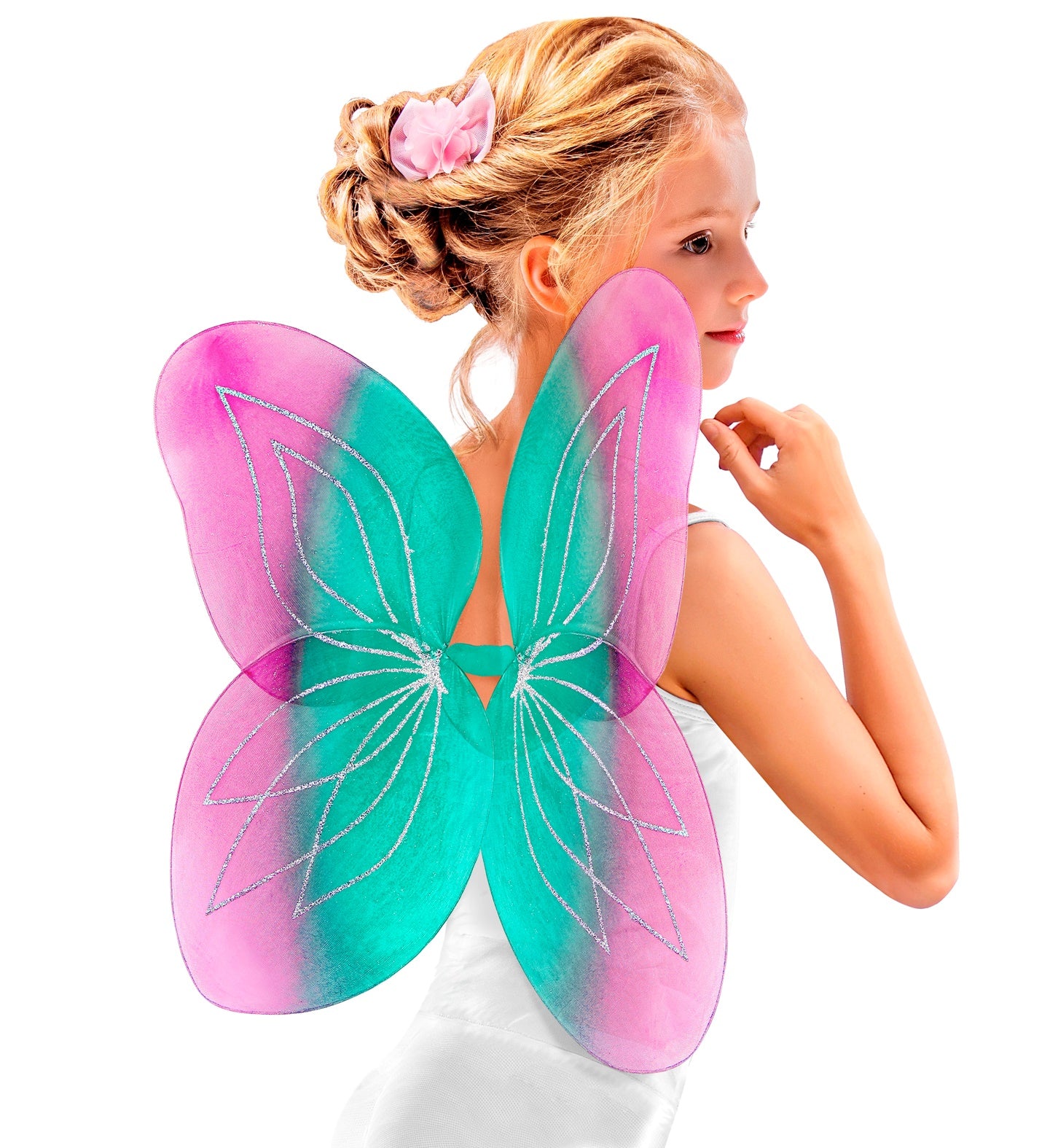 A young girl with blonde hair in a bun and a pink flower accessory is shown from the back wearing large translucent fairy wings with a pink-to-turquoise gradient and silver glitter line details, against a plain white background.