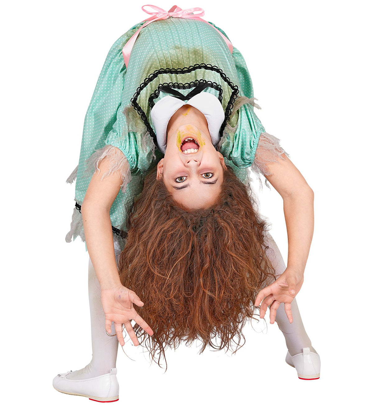 A girl in a possessed nightgown costume bending over backwards in a creepy crab-walk pose, with messy hair and special effects makeup on her face.