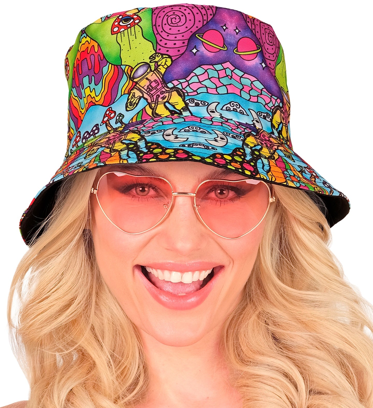 A smiling woman wearing the colourful psychedelic bucket hat and pink heart-shaped sunglasses.