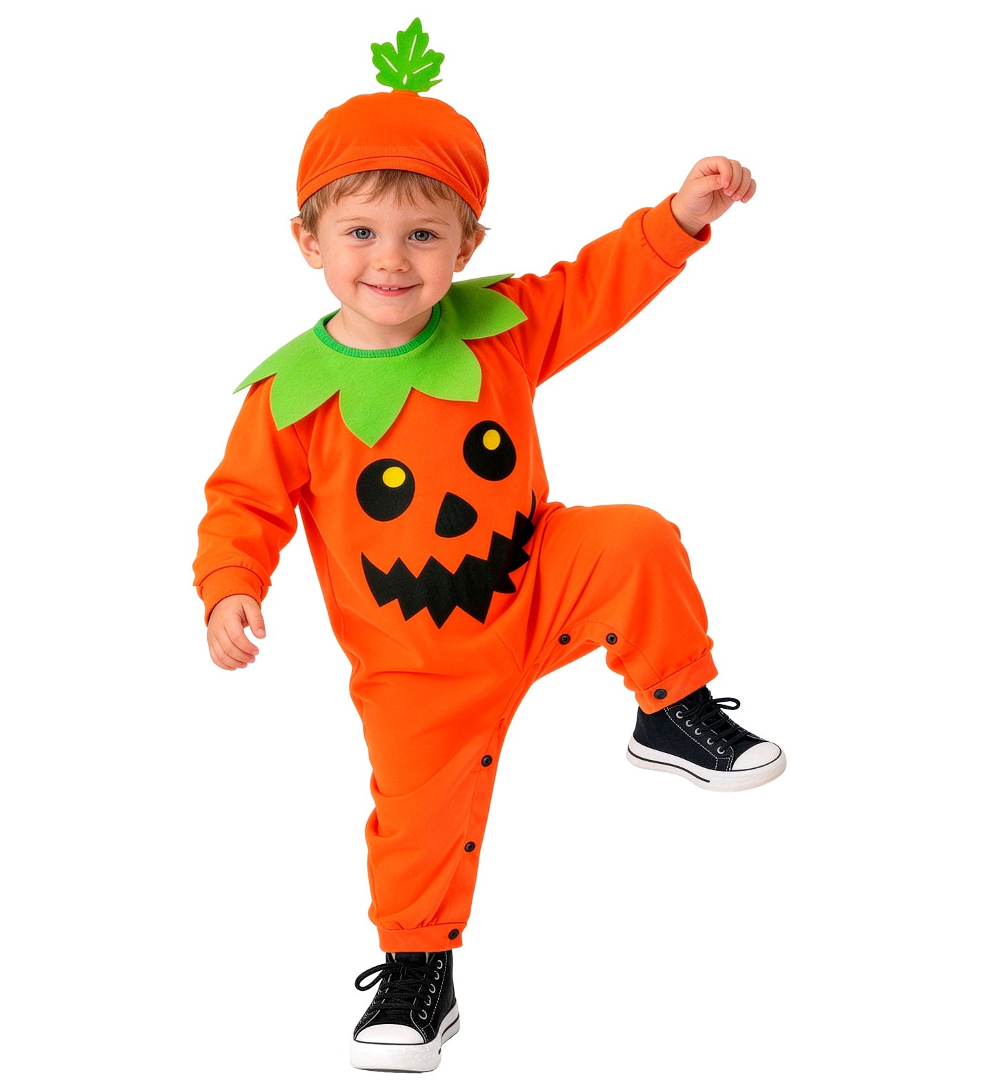 A smiling child happily lifting one leg playfully while wearing a bright orange pumpkin fancy dress jumpsuit with a black jack-o'-lantern face, green leaf collar, and a matching orange hat with a green stem.
