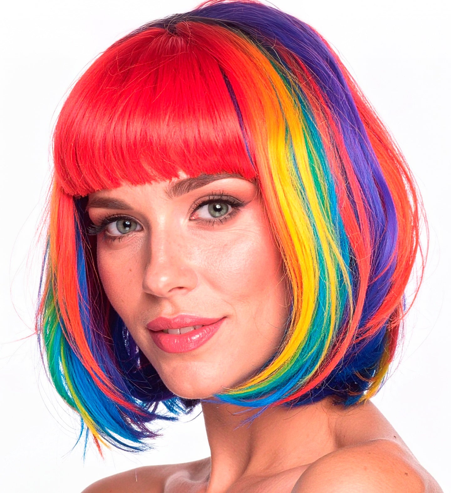 A close-up of a woman wearing a colourful rainbow bob wig with vertical stripes of red, yellow, blue, and purple.