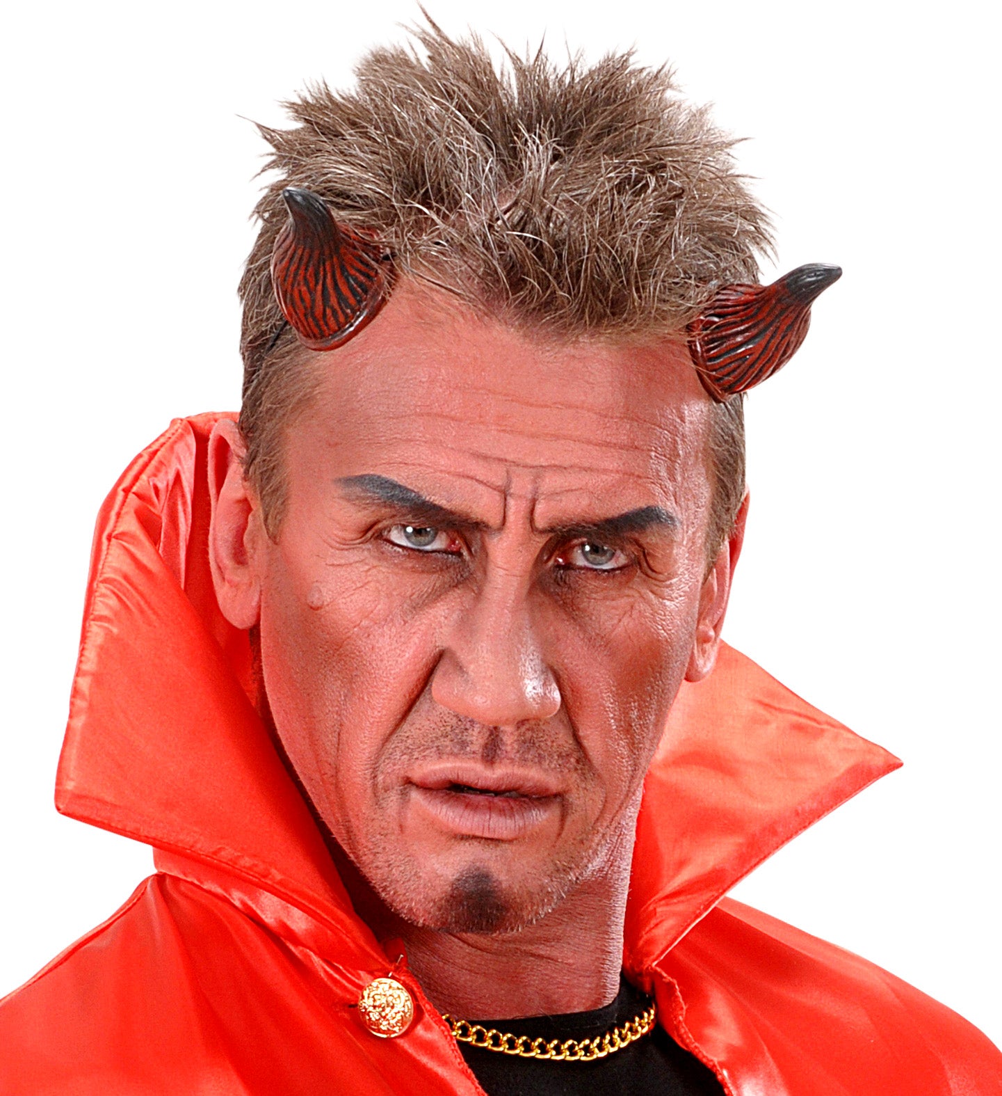 A man in a devil costume with horns and a cape, using the red face paint to cover his face for a spooky look.