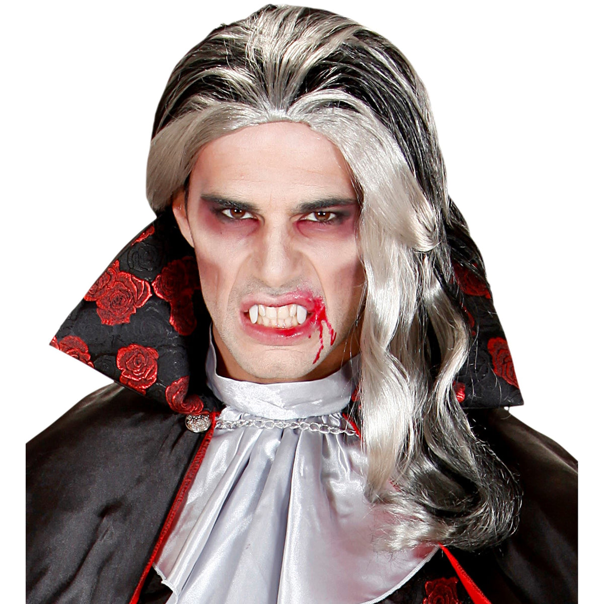 A man wearing a long silver-and-black wig with a black cape featuring red rose print, a silver cravat, and dramatic vampire makeup with fake blood on his lips and around his eyes, against a plain white background.