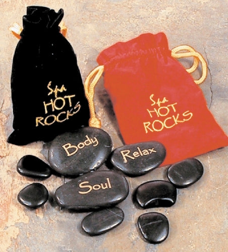 Two gift bags, one black and one red, each with a different text on them. The black bag and red bag has 'SPA HOT ROCKS' written in gold. Black stones labeled 'Body', 'Relax', 'Soul' with black and red bags on a textured surface.