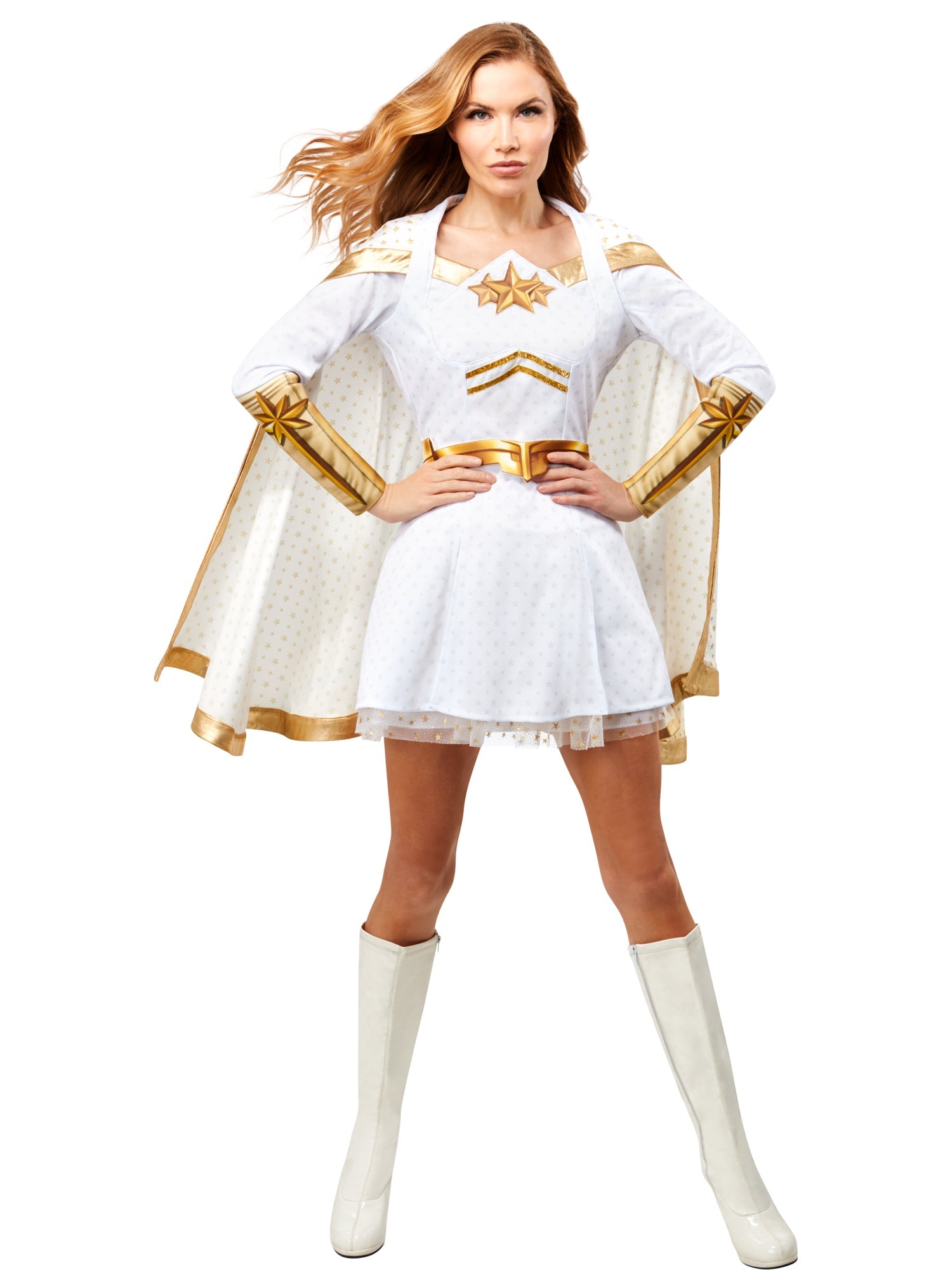 A woman models a Starlight costume from The Boys, featuring a white and gold dress with an attached cape, posing with hands on hips.