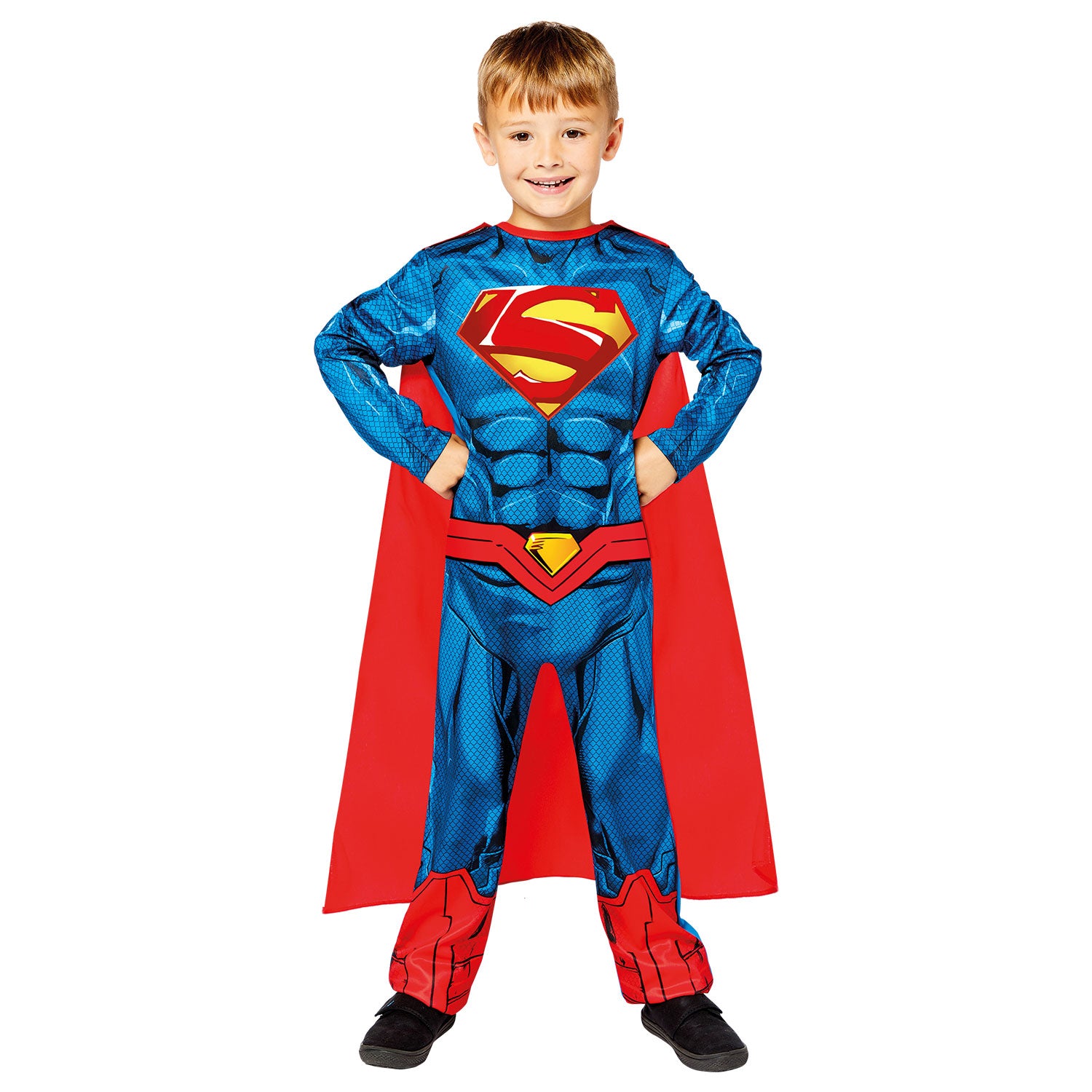 A child in a Superman costume stands with hands on hips, showing the iconic 'S' shield on the chest of the printed jumpsuit.