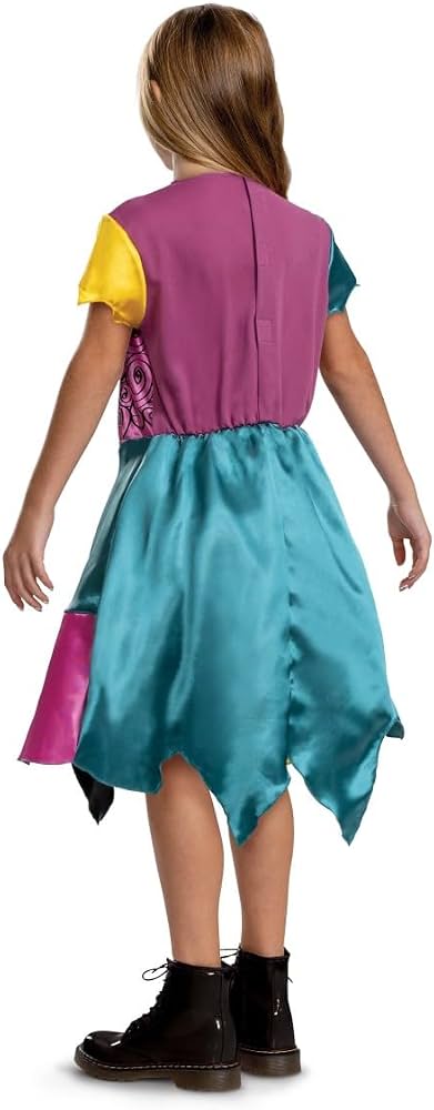 Back view of child in Sally costume showing full patchwork dress with velcro closure seam, jagged hemline and contrasting fabric colour blocks in yellow, pink, blue and black