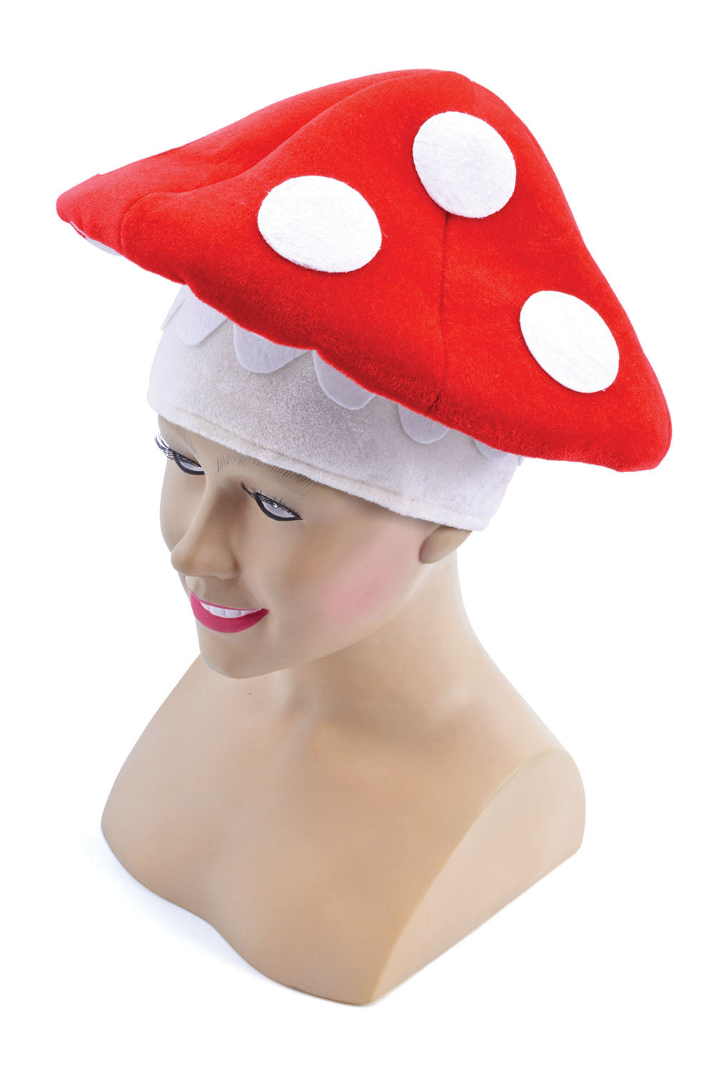 A plush red and white toadstool mushroom fancy dress hat displayed on a mannequin head, showing a wide red cap with white spots and a soft white fabric base with a scalloped trim.