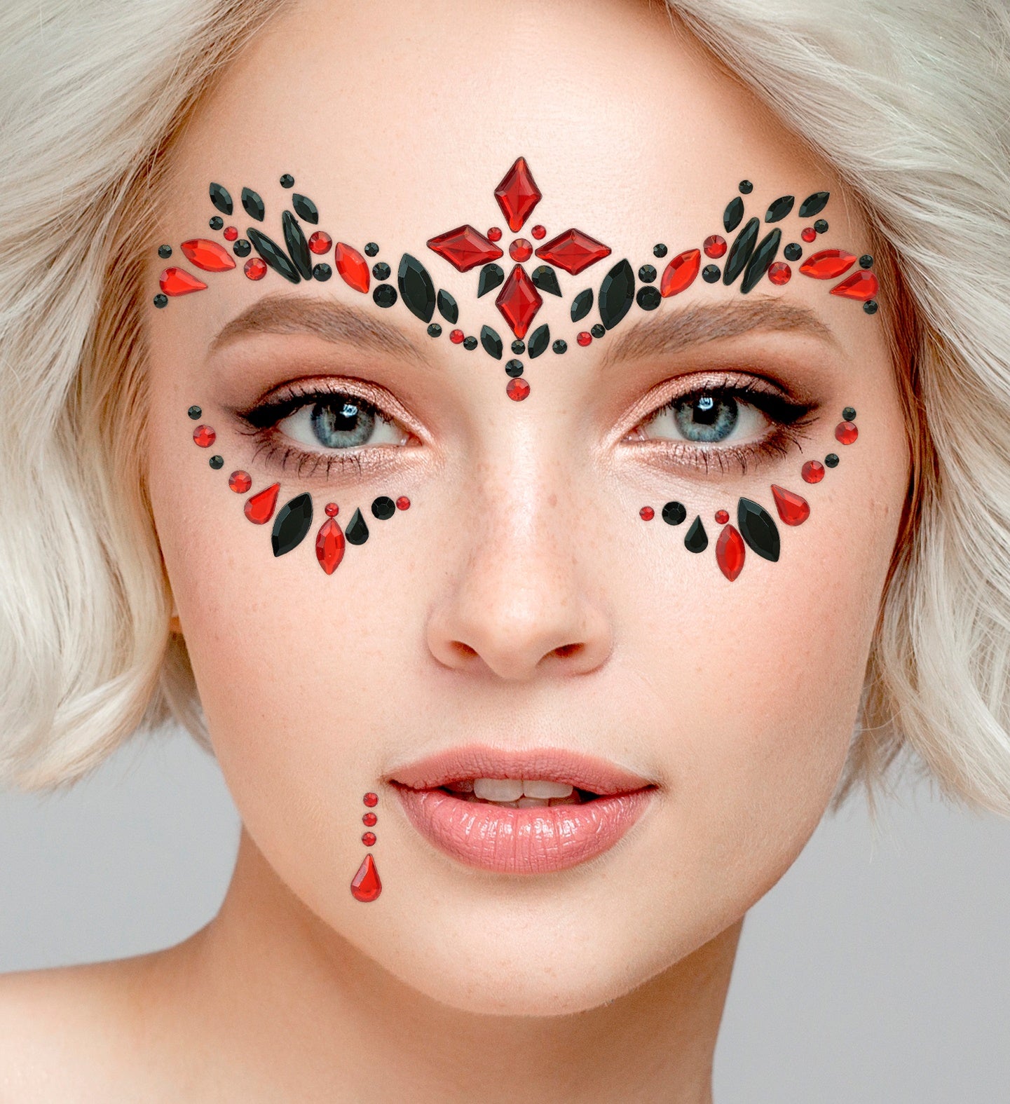 Close-up of symmetrical red and black gem forehead jewels and matching eye accents for a vampiress costume.