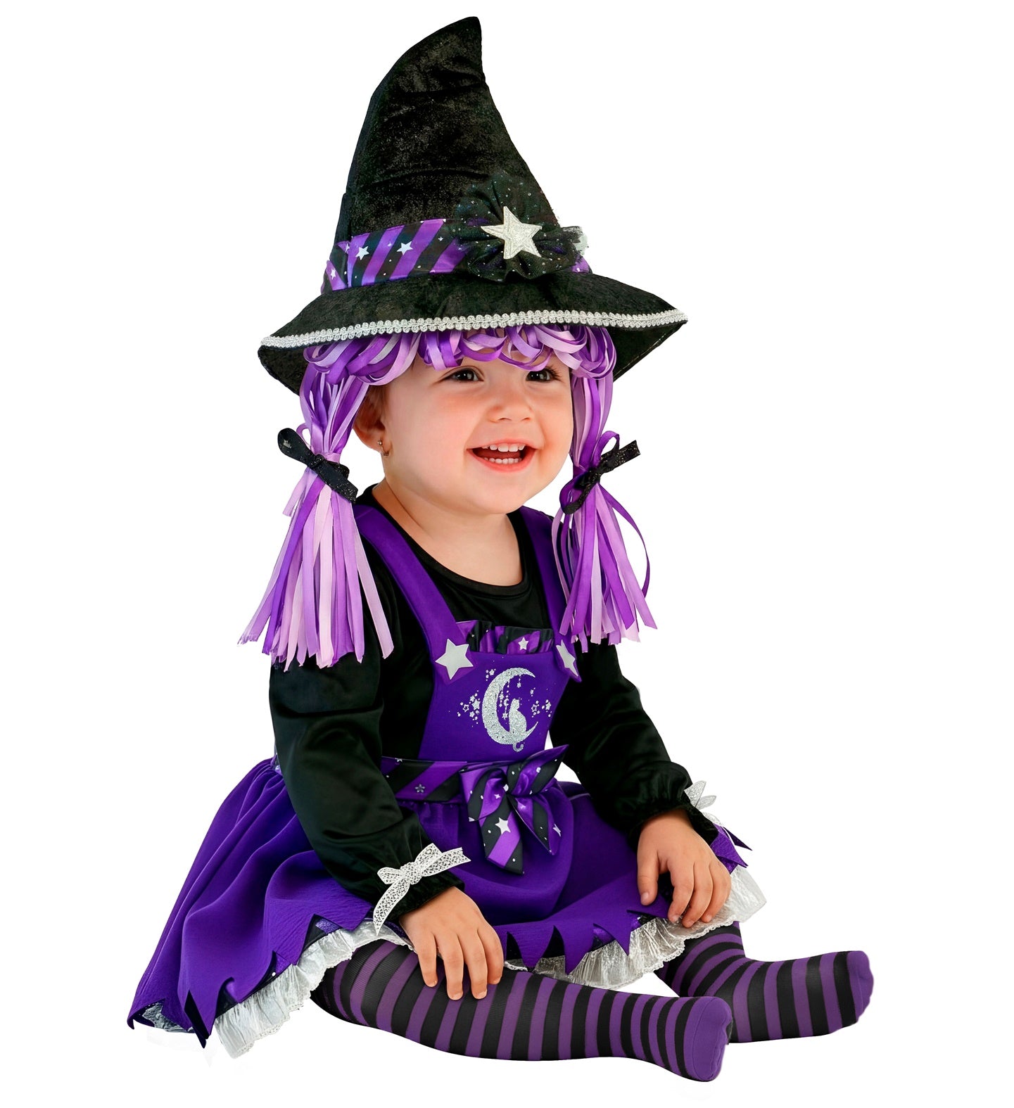 A smiling baby sitting down wearing a purple and black Halloween witch costume, featuring a dress with a silver moon graphic, striped tights, and a witch hat with attached purple ribbon hair.