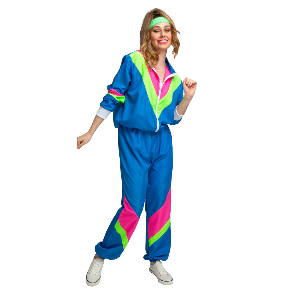 Woman smiling and dancing in a vibrant blue 80s shell suit costume with neon pink and green details and a green headband.