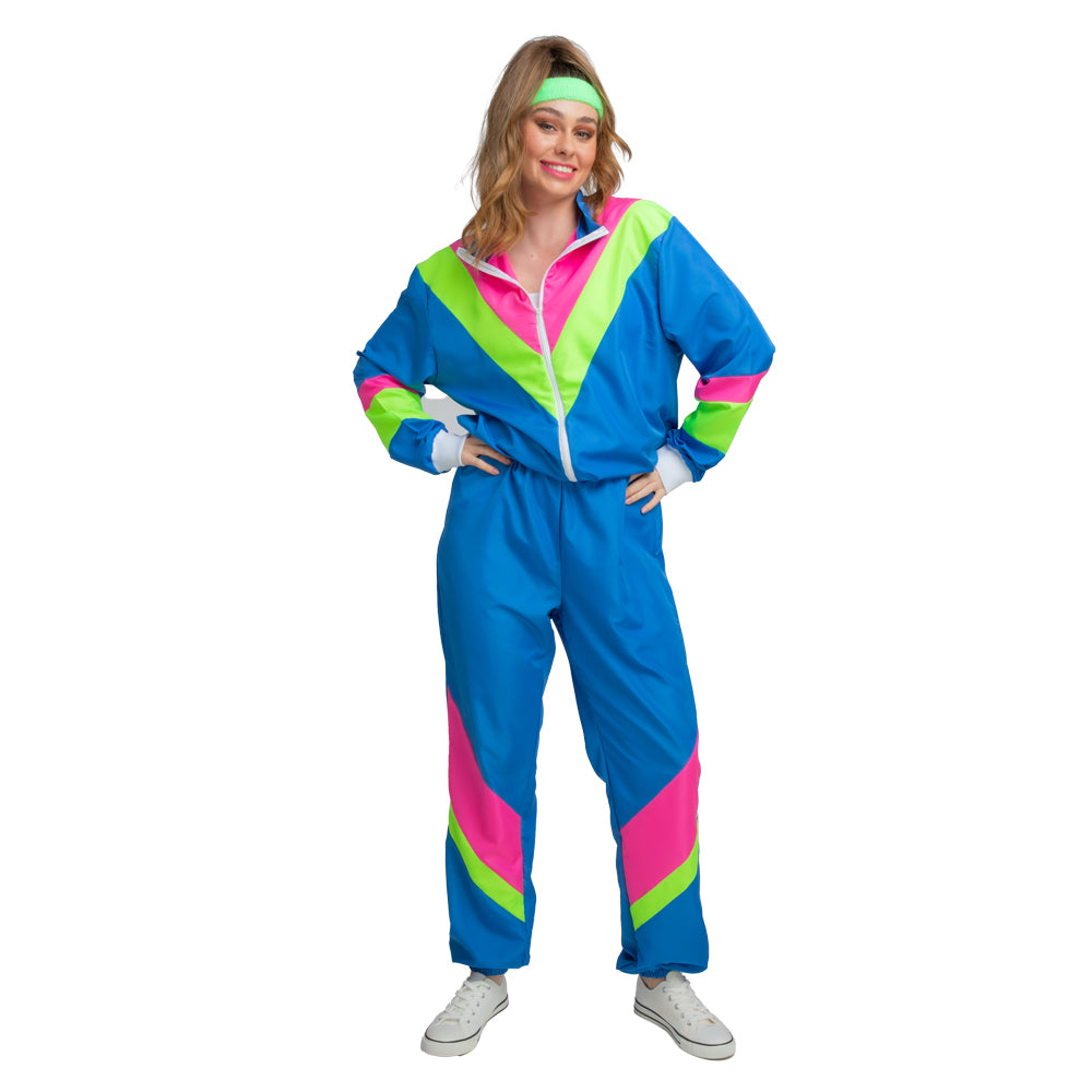 Woman posing confidently in a classic blue 80s shell suit costume featuring bright neon pink and green geometric panels.