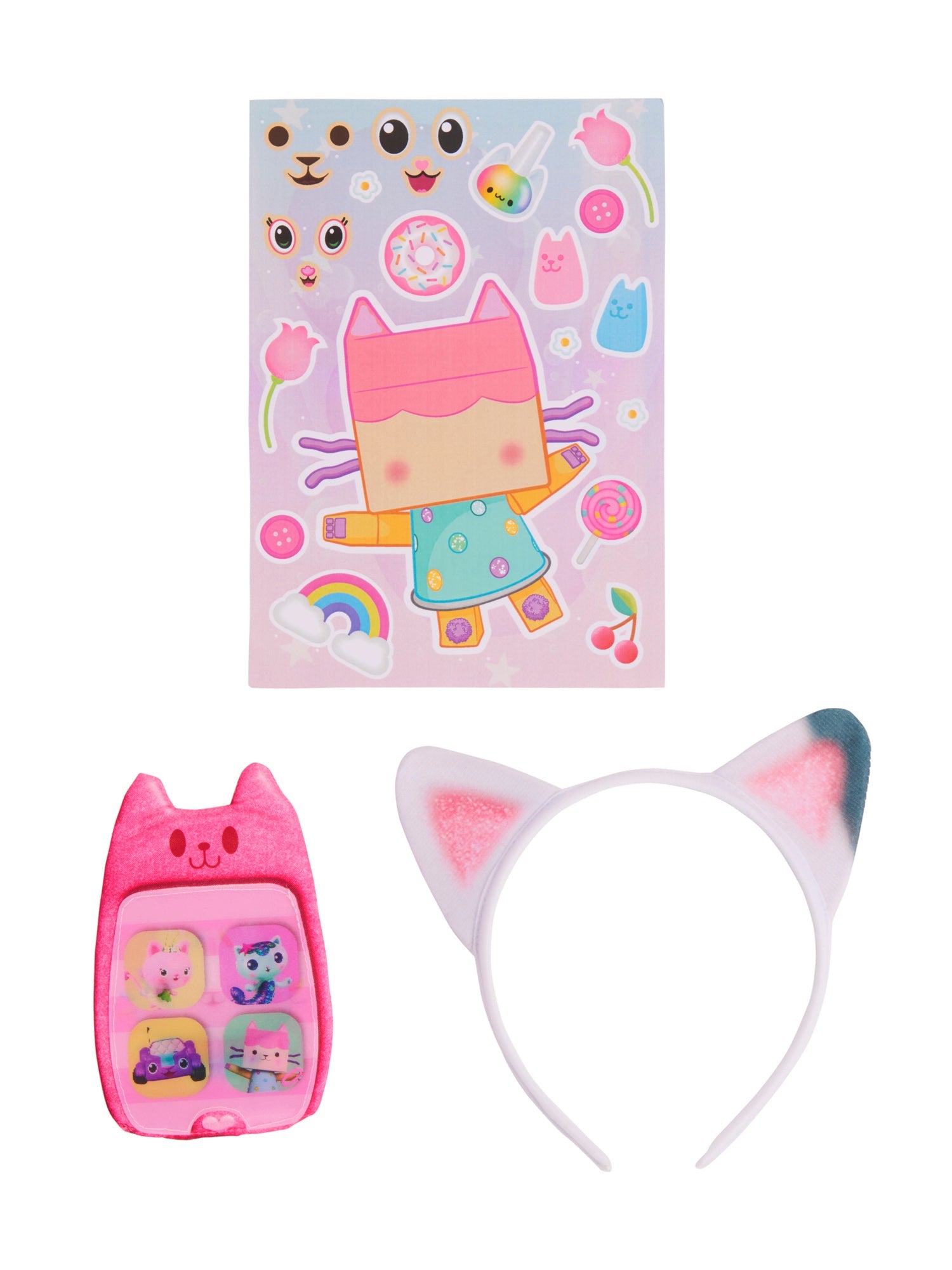 A flat lay display of the Gabby's Dollhouse costume accessories, featuring a colorful character sticker sheet, a pink plush lenticular toy phone, and a white and pink cat-ear headband.