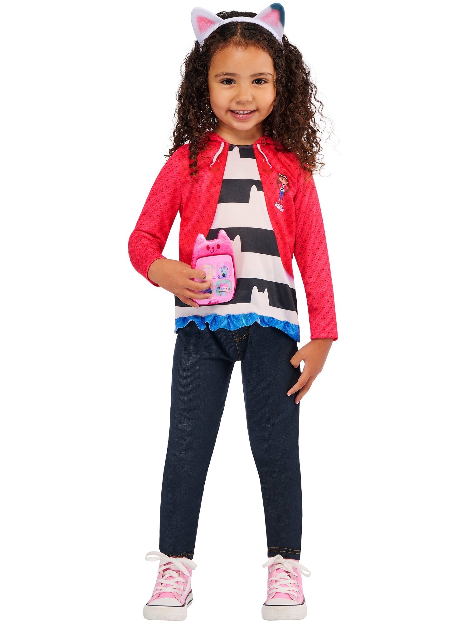 A child wearing the Gabby's Dollhouse striped top, pink jacket, and cat-ear headband, happily holding the plush pink lenticular toy phone.