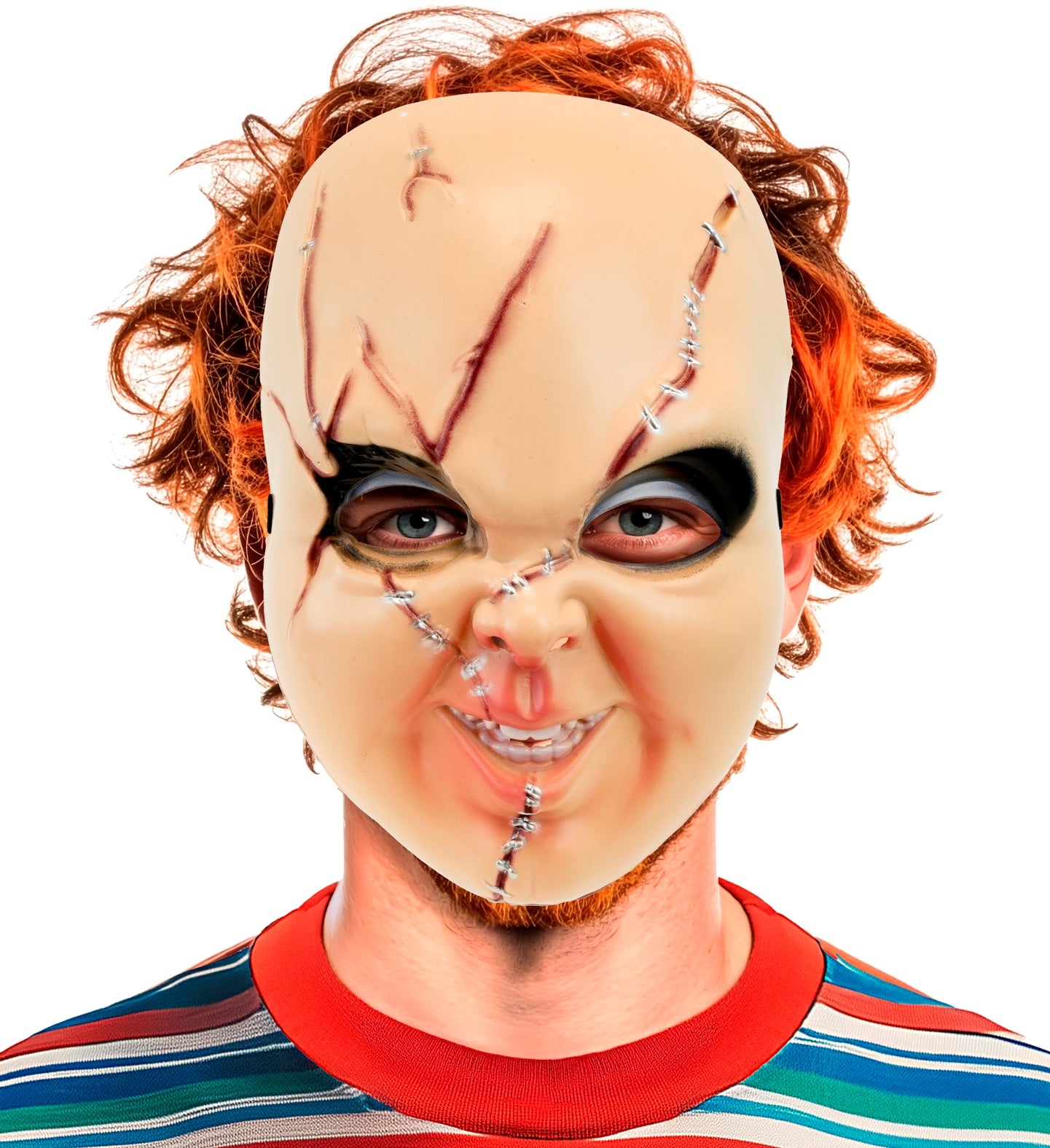 A model staring menacingly at the camera wearing a 'Good Boy' hard plastic killer doll mask featuring deep facial scars, styled with a messy orange wig and a colorful striped shirt.