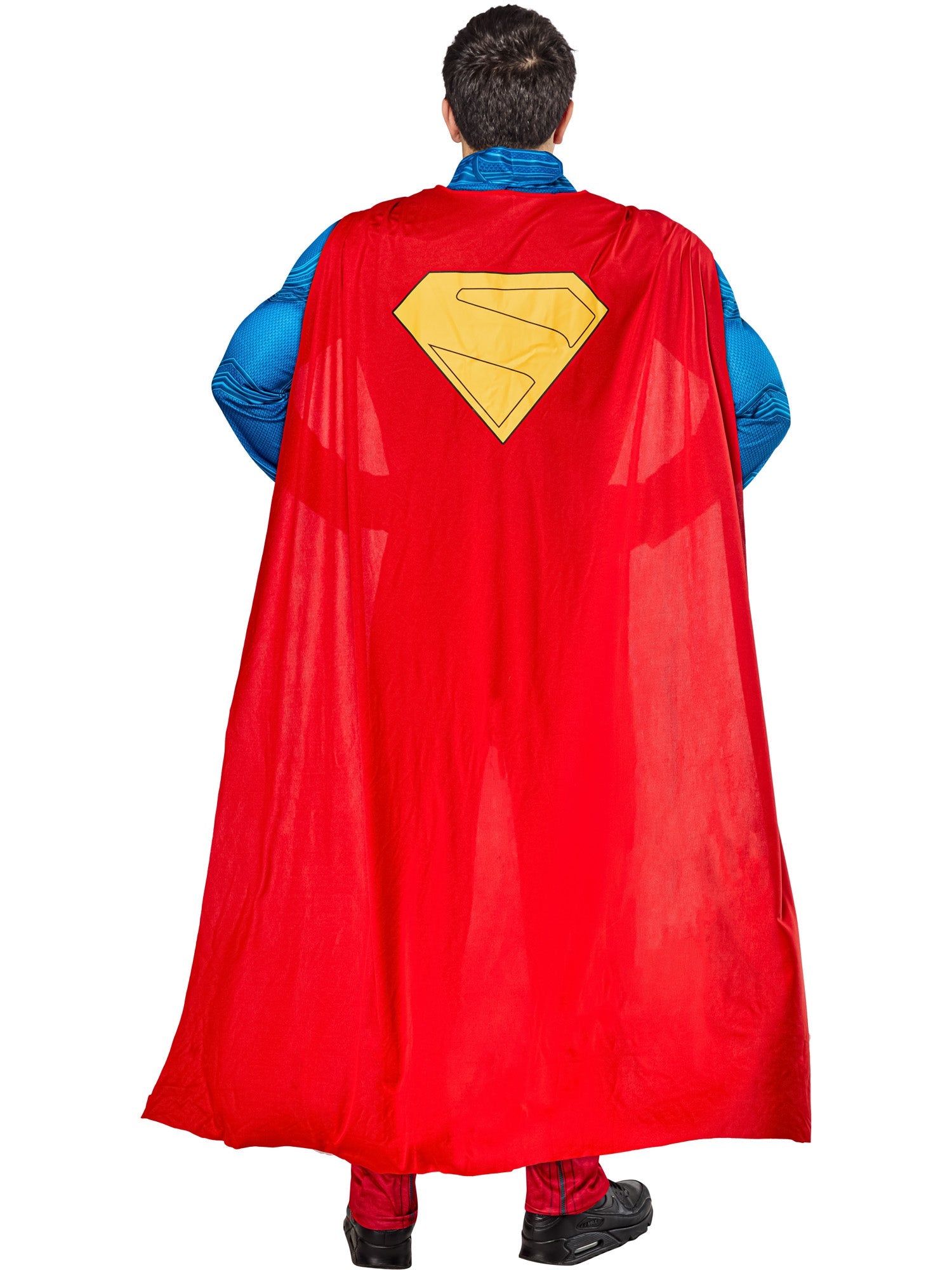 A back view of a person in a Superman costume, showing the red cape with a yellow "S" emblem hanging down, covering their back.