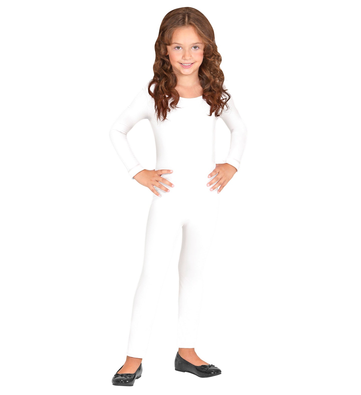 A young girl with long wavy hair smiling while posing with hands on her hips, wearing a long-sleeved children's white nylon and lycra bodysuit with black flat shoes.